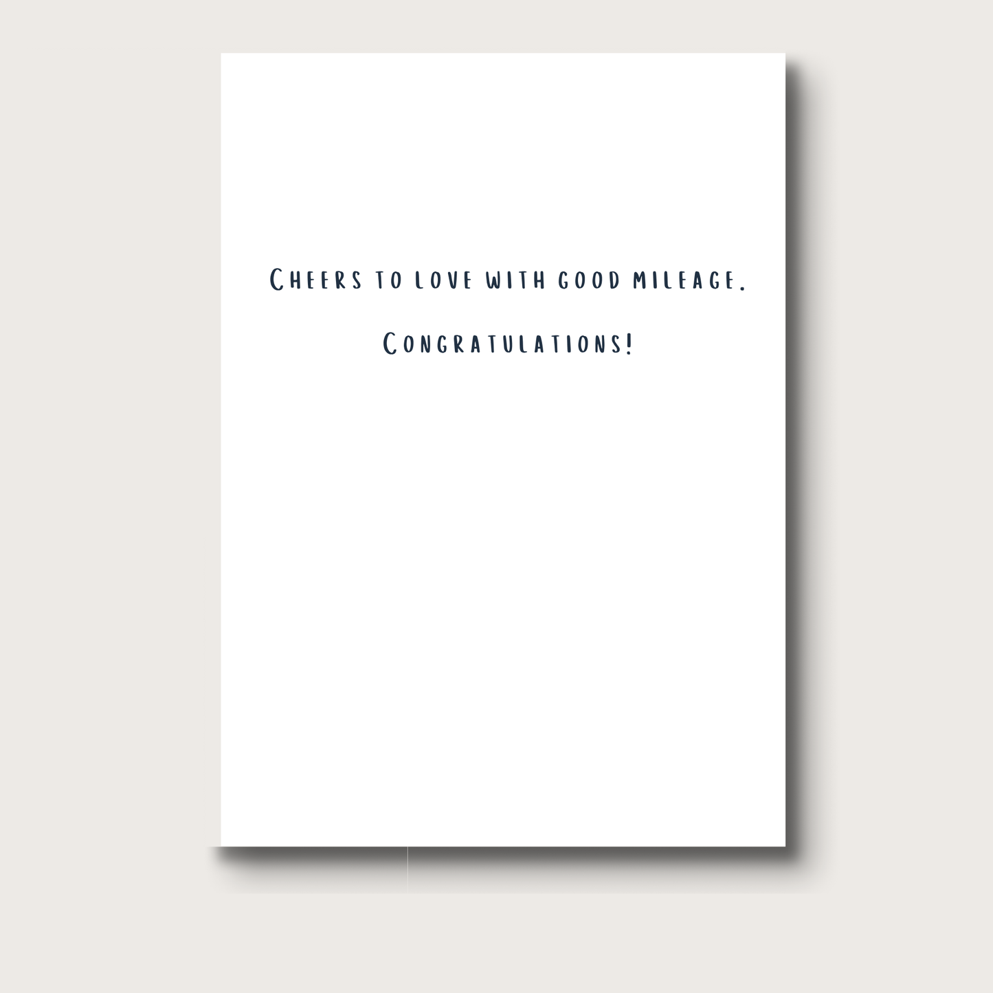 Inside of the card reads, "Cheers to love with good mileage. Congratulations!"