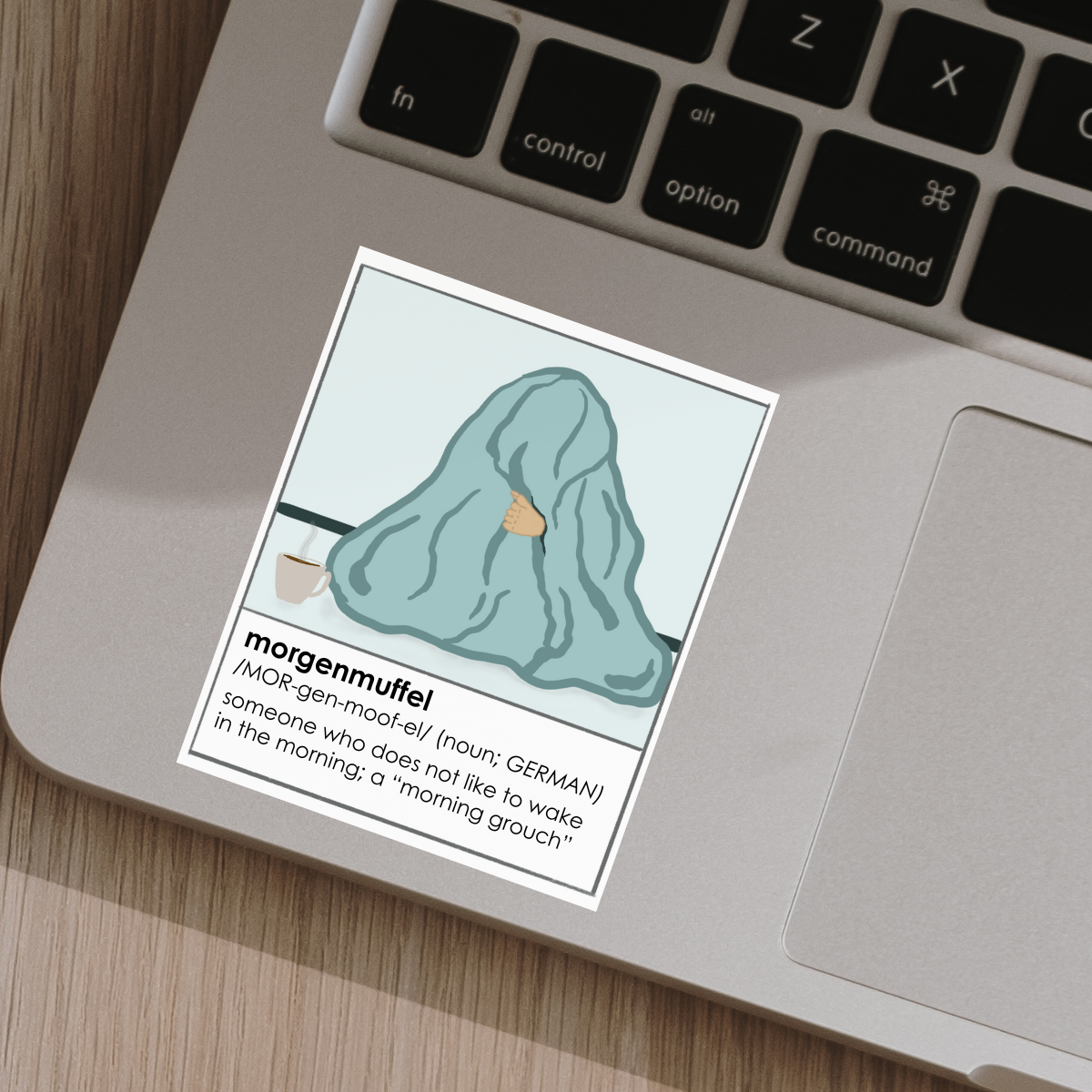Sticker with a definition of 'morgenmuffel' on a laptop