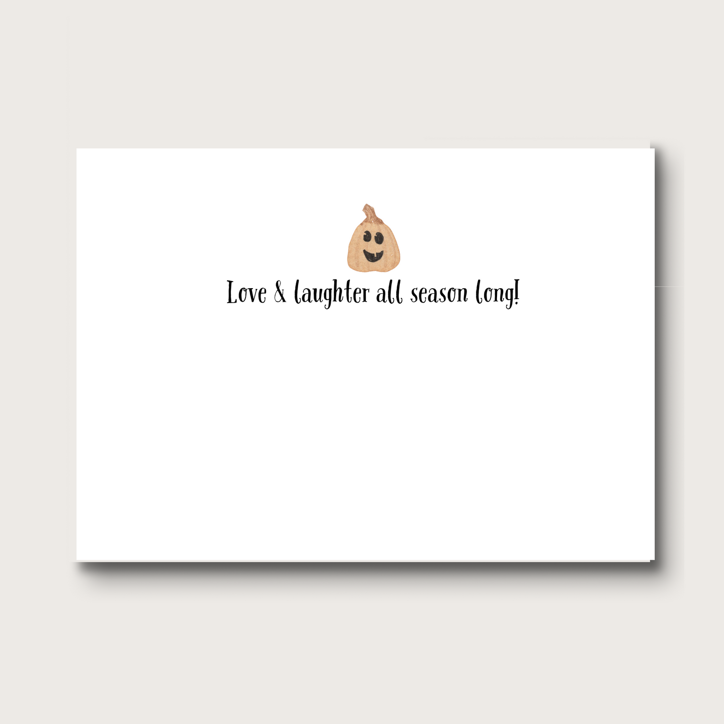 Inside of note card with a pumpkin face emoji and text 'Love & laughter all season long!' on a white background