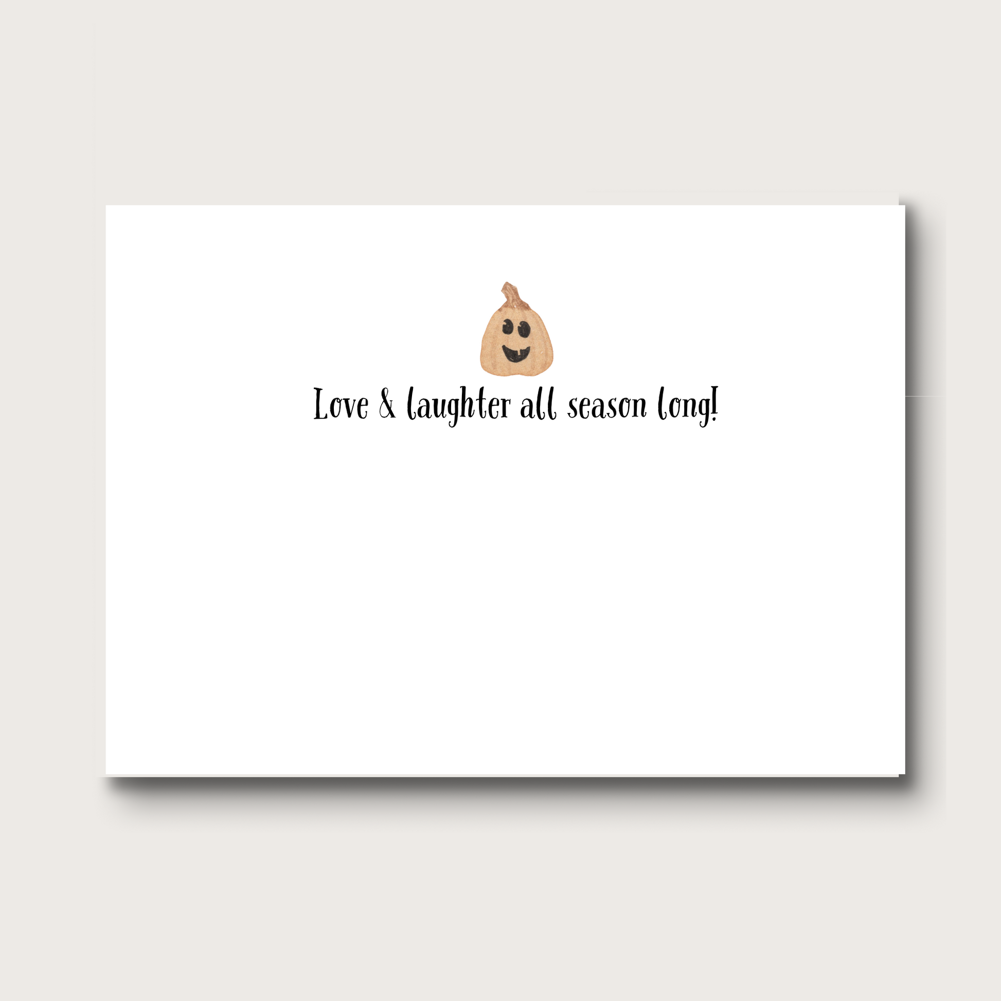 Inside of note card with a pumpkin face emoji and text 'Love & laughter all season long!' on a white background