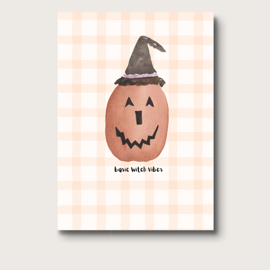 Notebook cover with a jack-o'-lantern wearing a witch hat on a gingham background. Underneath reads "basic witch vibes"