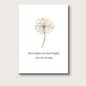 A white dandelion puff on a white background that reads "Even when you feel fragile, you are strong." A card meant to support during illness, or hospice care, or other difficult challenges. 