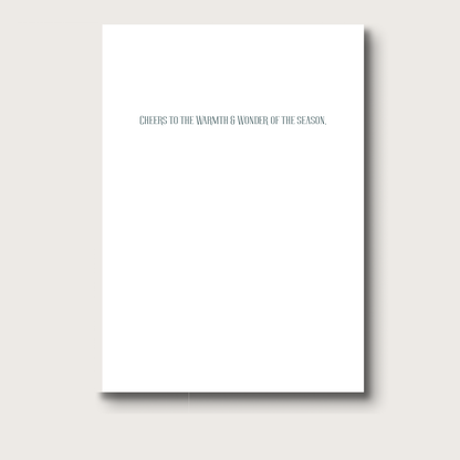 White greeting card with text 'Cheers to the warmth & wonder of the season' on a white background