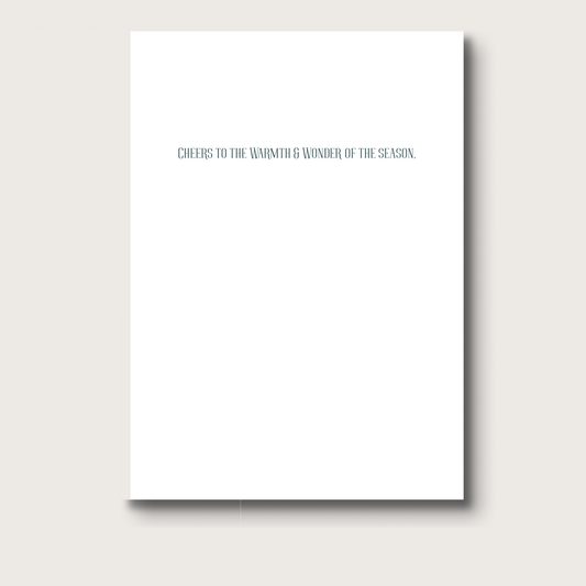 White greeting card with text 'Cheers to the warmth & wonder of the season' on a white background