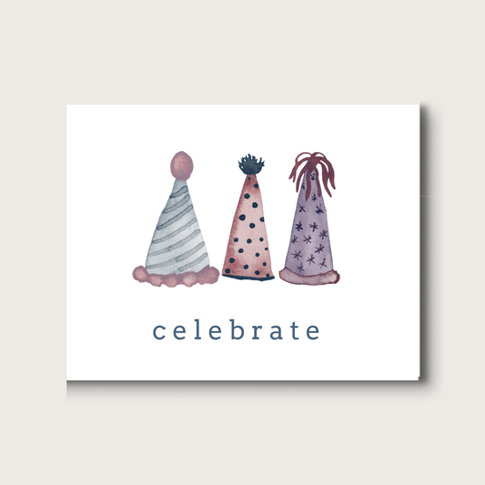 Three softly colorful party hats with the word 'celebrate' on a white background
