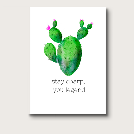 Digitally created watercolor greeting card featuring a green cactus with subtle texture. Below the cactus, the phrase "stay sharp, you legend" appears in vintage typewriter-style font. A fun and quirky card for encouragement or celebration.