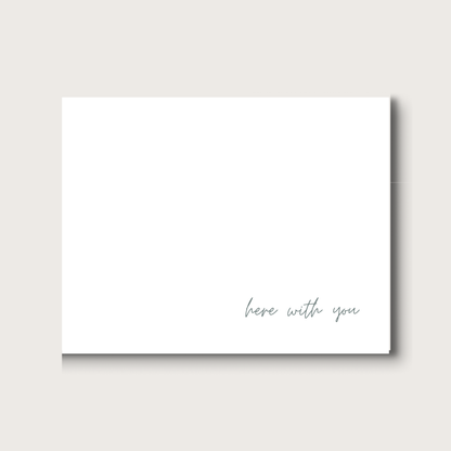 White card with 'here with you' text on a white background