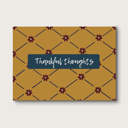 Notecard with 'Thankful thoughts' on a golden patterned cover