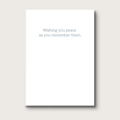 White card with text 'Wishing you peace as you remember them' 