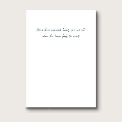 White card with black text that reads "May these memories bring you warmth when the house feels too quiet" 